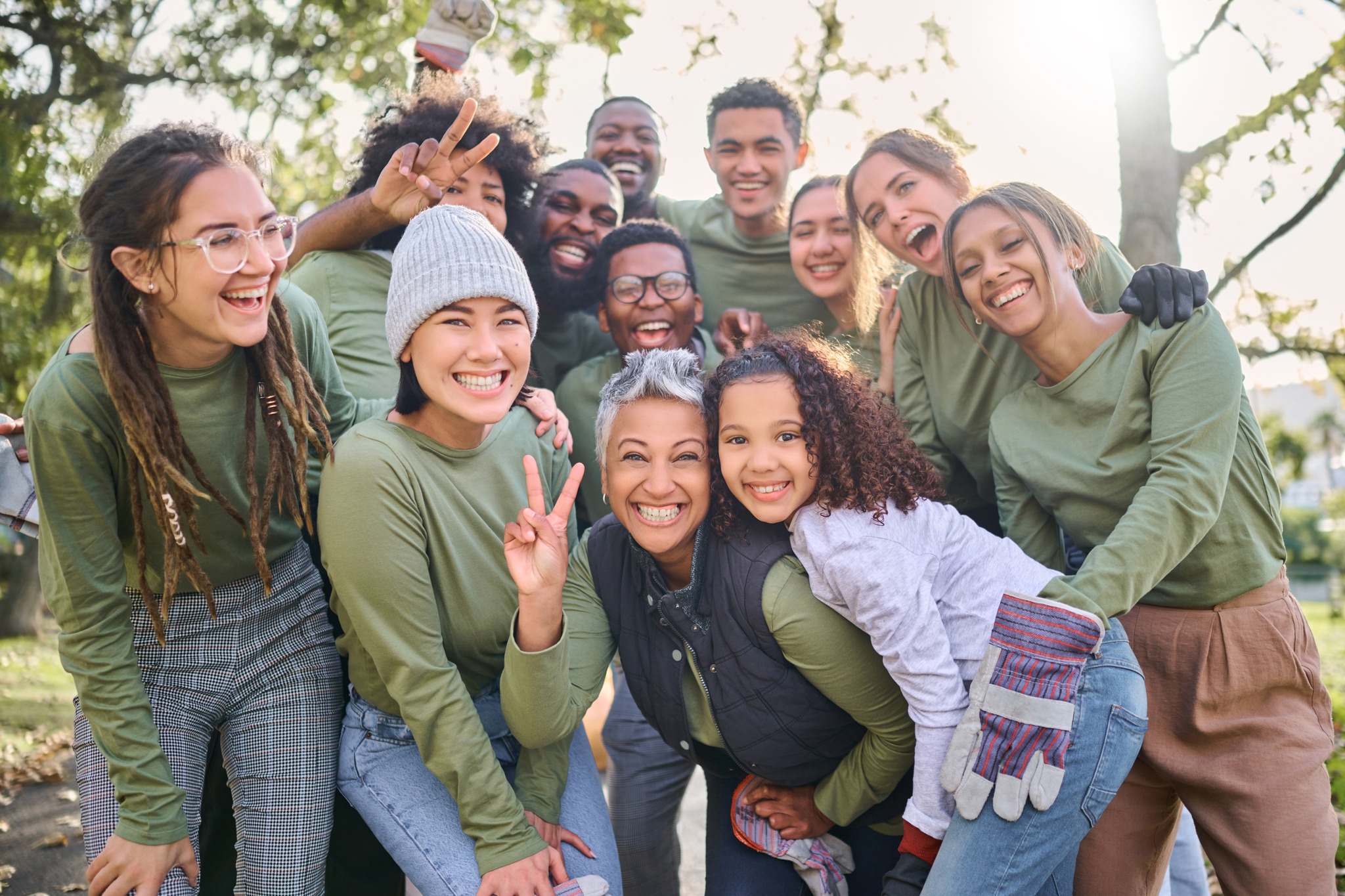 Portrait, peace or teamwork with a community friends group in a park to volunteer for charity together. Earth day, nature or support with a team of people outdoor to recycle or change the environment.